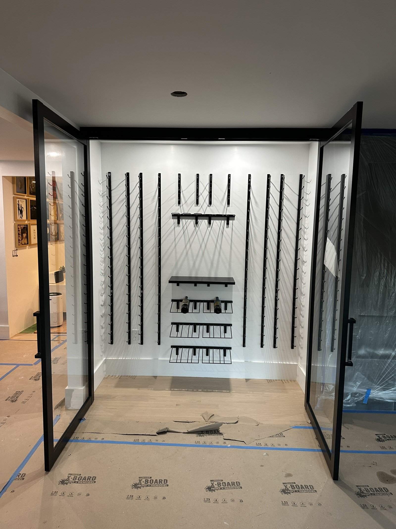 Detail of the finished wine room with the glass door open